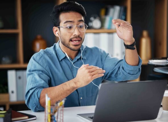 "Professional consulting session over video call with a business expert using a laptop.