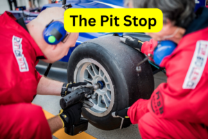 pit crew changing a race car tire quickly during a pit stop