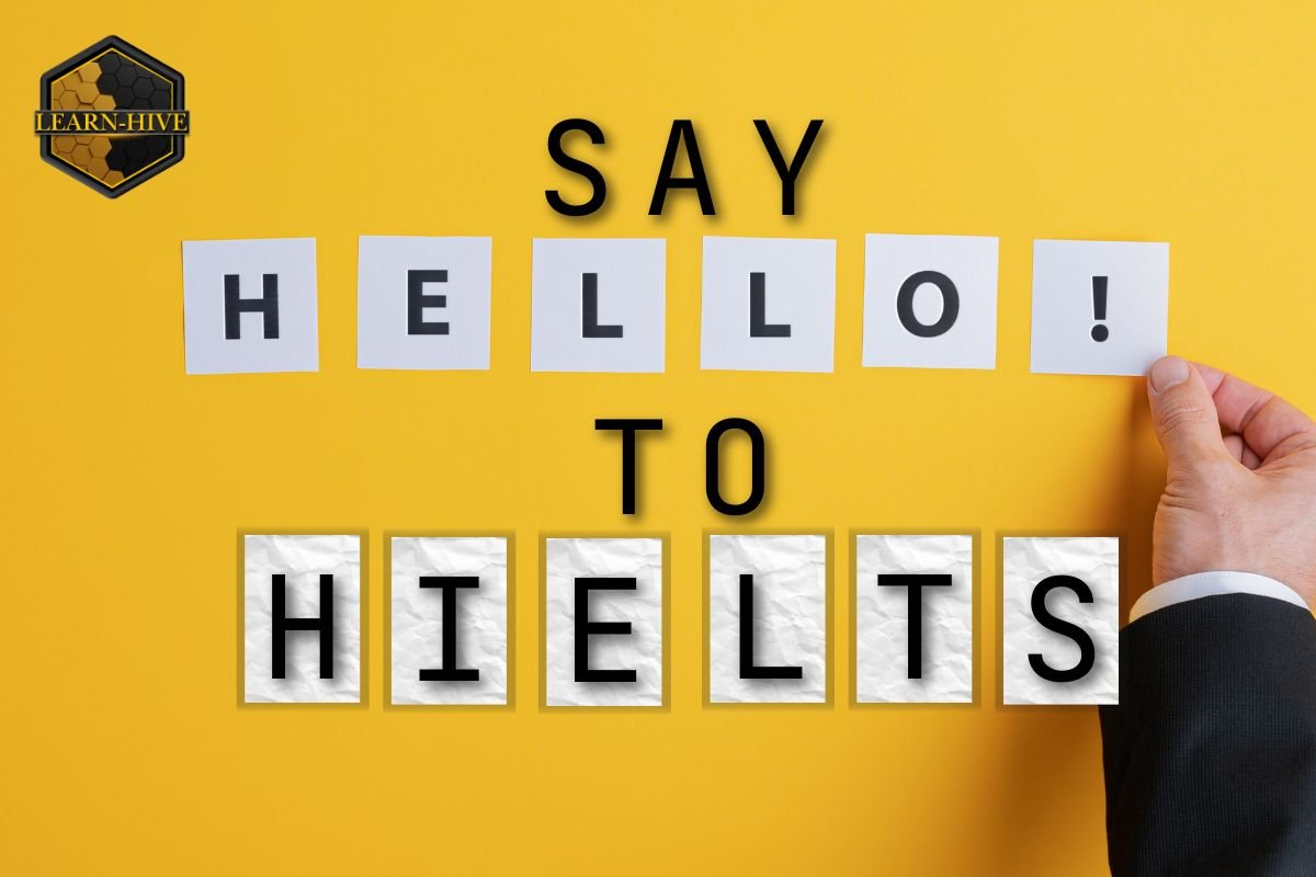 Yellow background with text saying “Say Hello to HIELTS” using letter cards, and the Learn-Hive logo in the top left corner.