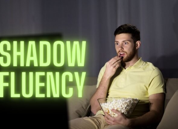 Man watching TV with popcorn, learning through the Shadow Fluency method.