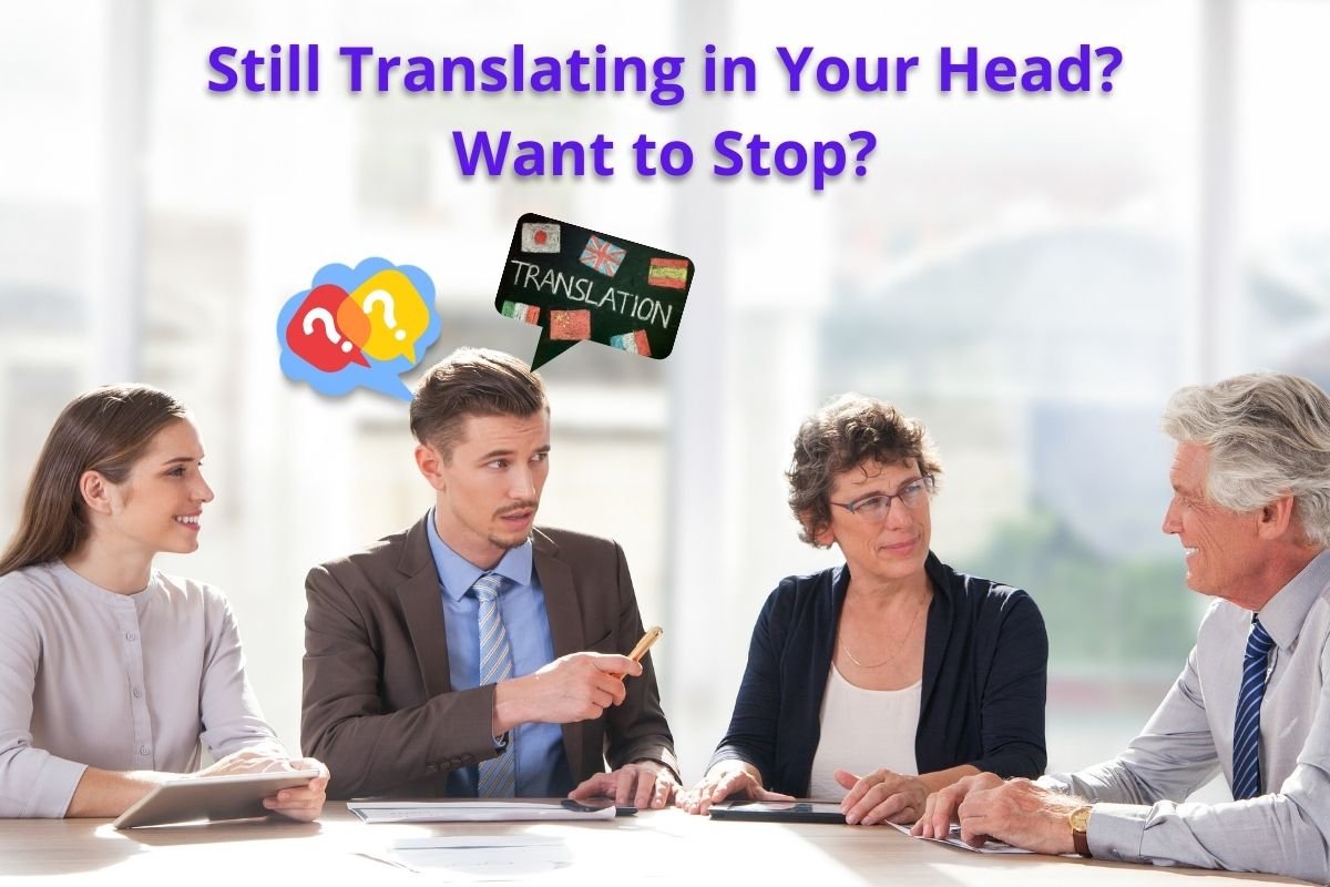 Business professionals sitting around a meeting table, with one man appearing confused and a speech bubble showing a “Translation” sign, representing the challenge of mentally translating in English conversations.